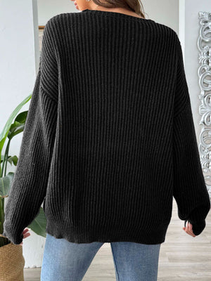 Black ribbed knit sweater with off-shoulder neckline and contrast trim detail.