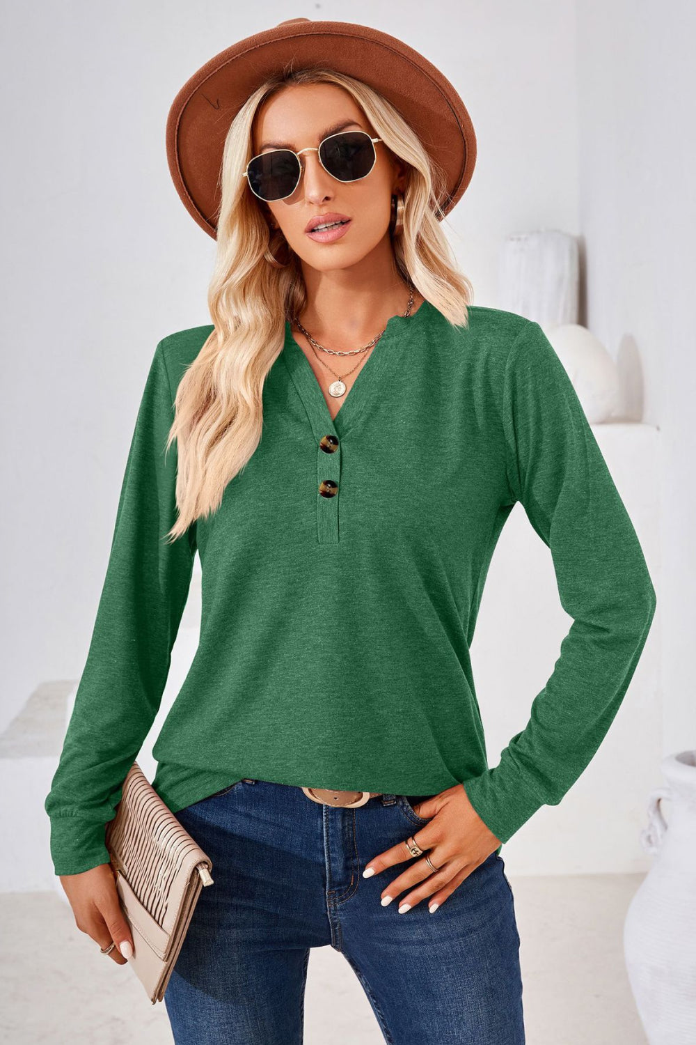 Dark green henley neckline jersey top with button detail and long sleeves.
