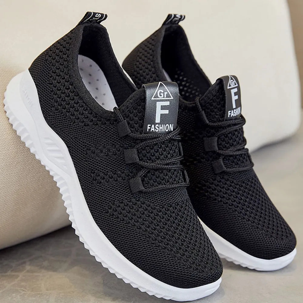 Black breathable knit runner sneakers with white soles and logo detail.
