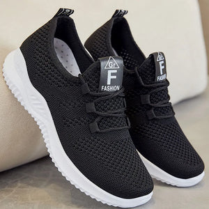 Black breathable knit runner sneakers with white soles and logo detail.