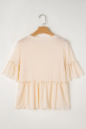 Beige textured blouse with ruffle hemline and flutter sleeves.