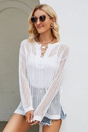 White lace-up openwork knit tunic with long sleeves and a v-neckline.