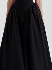 Black halter neck midi dress with gathered skirt detail and pockets.