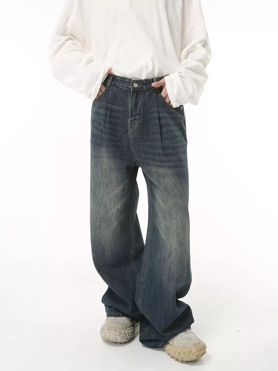 Men's dark wash wide leg denim jeans with front pleats and a relaxed fit.