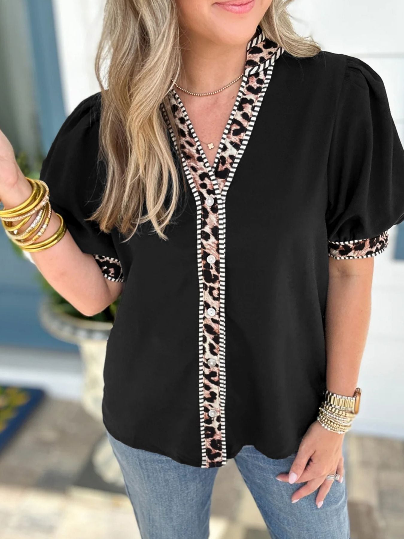Black puff sleeve blouse with leopard trim and button front.