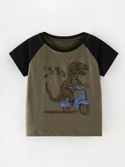 Toddler t-shirt with dinosaur graphic on scooter, crew neck, cotton, raglan sleeves.