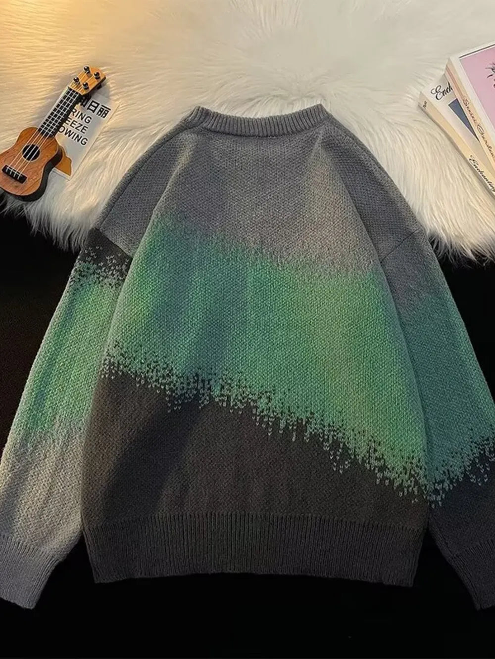 Gradient color block oversized knit sweater with crew neck and chunky knit texture.