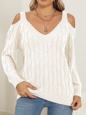 Ivory cable knit cold shoulder sweater with V-neck and balloon sleeves.