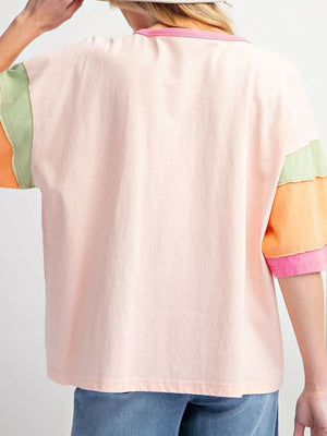 Colorblock tee with pink, orange, green, and watermelon pink sleeves and neckline.