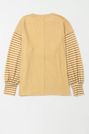 Maternity shirt in mustard with bishop sleeves featuring brown stripes and a crew neck.