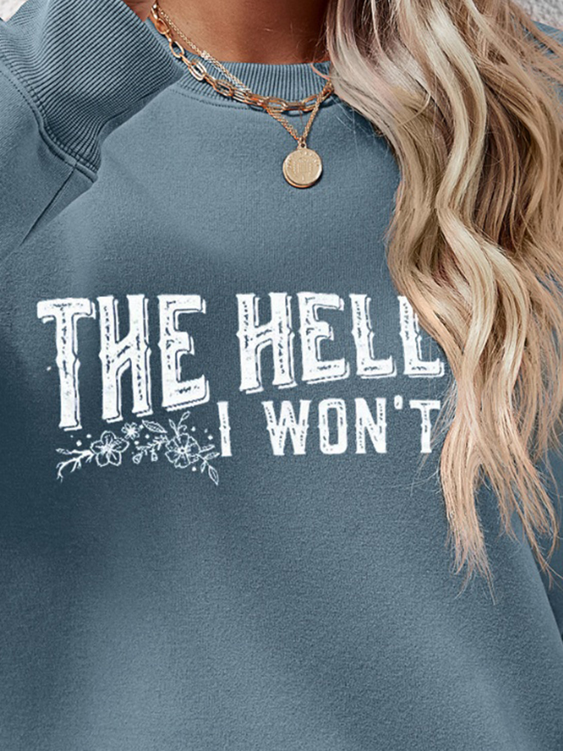 Graphic crewneck sweatshirt in Misty Blue with white text and floral detail.