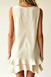 Beige polyester mini dress with V-neck, sleeveless, and double ruffle hem.