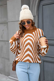 Caramel zebra stripe knit pullover sweater with voluminous sleeves.