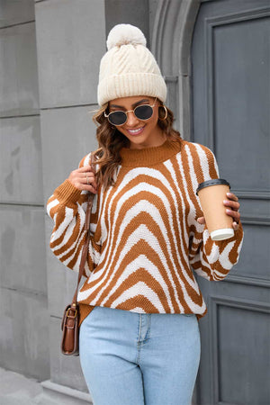 Caramel zebra stripe knit pullover sweater with voluminous sleeves.