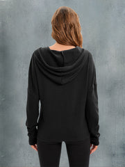 Black waffle knit relaxed fit hoodie with a hood and long sleeves.