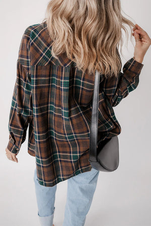 Plaid jacket in brown, green, and navy with button cuffs, styled with light wash jeans and a black crossbody bag.
