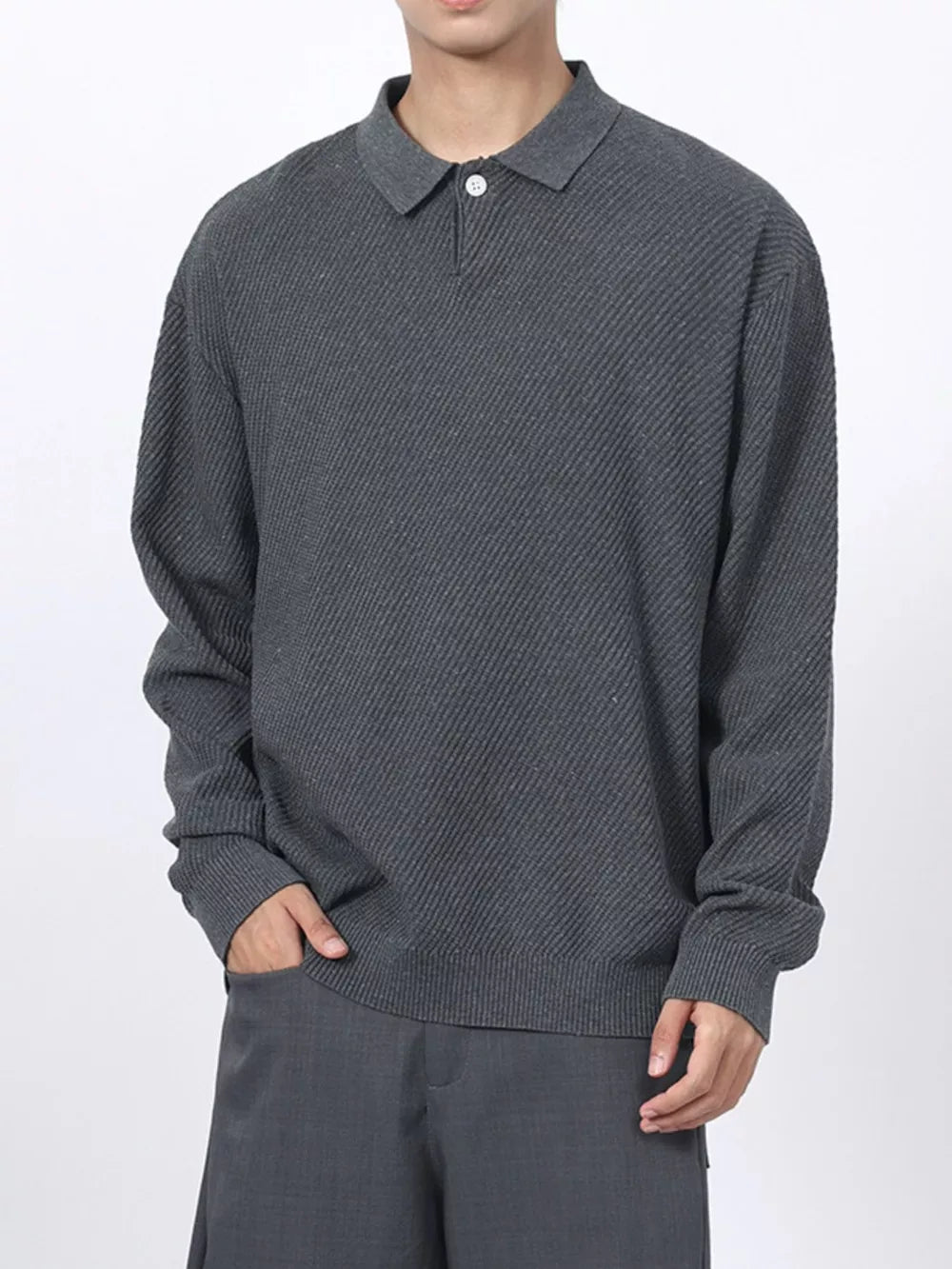 Men's dark gray textured knit polo shirt with a classic collar and button placket.