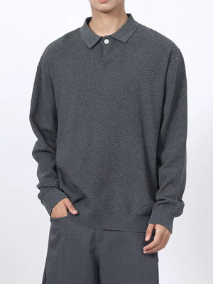Men's dark gray textured knit polo shirt with a classic collar and button placket.