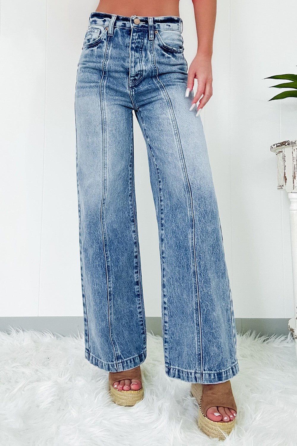 Seamed wide leg denim trousers in medium wash, featuring a high rise and flared leg.