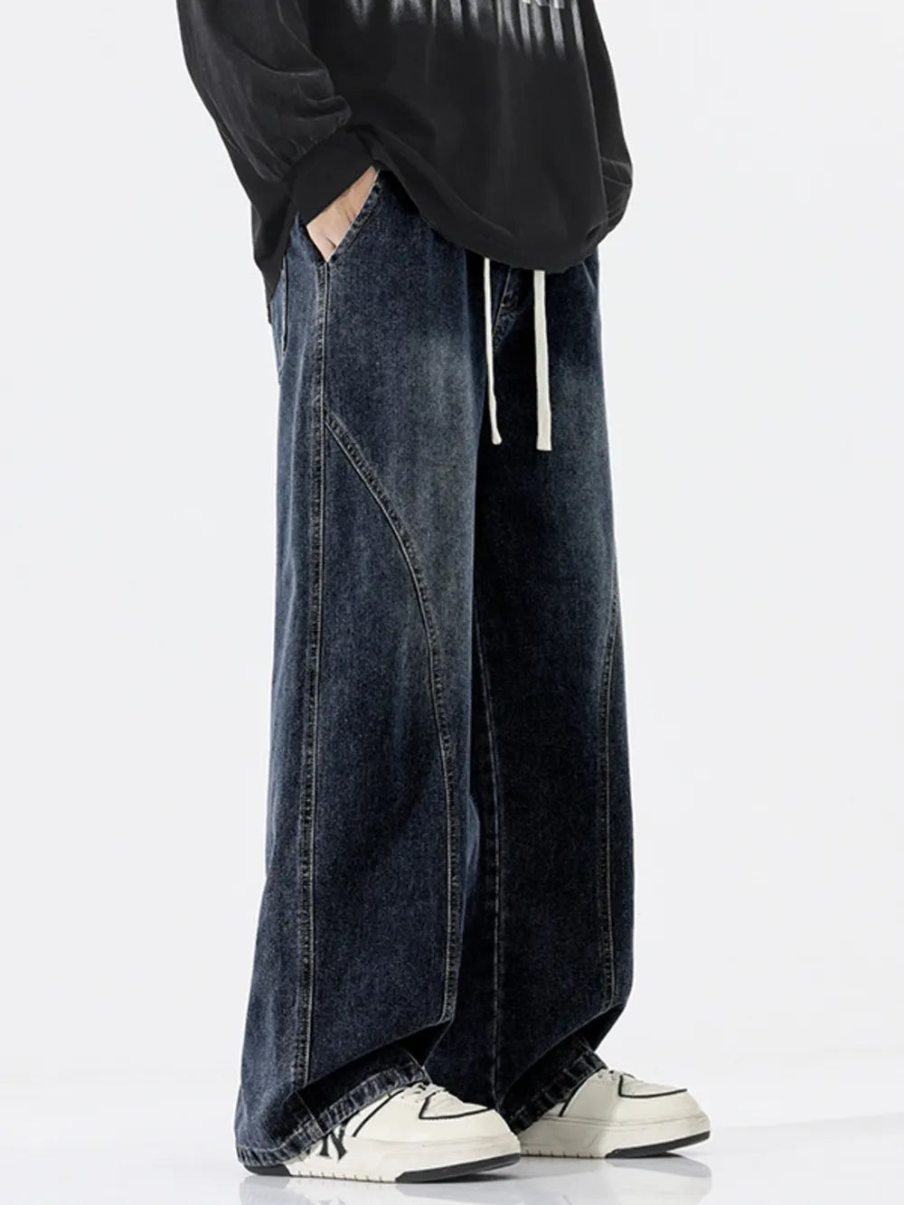 Relaxed fit dark wash wide-leg jeans with drawstring and contrast stitching.