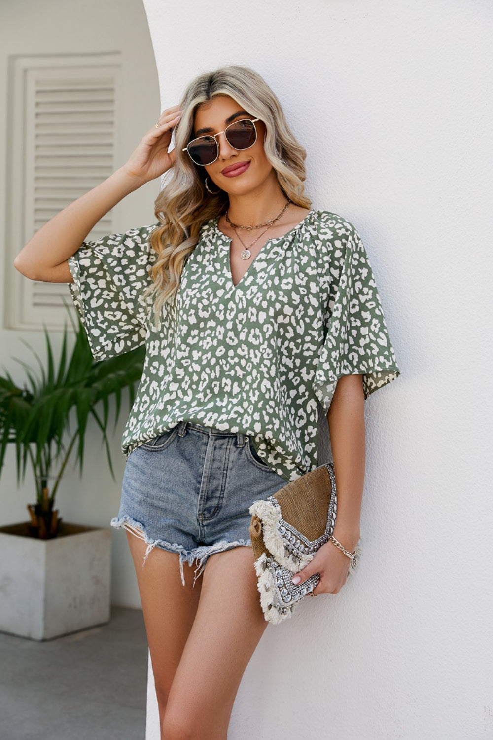 Army green leopard print v-neck blouse with short flutter sleeves.