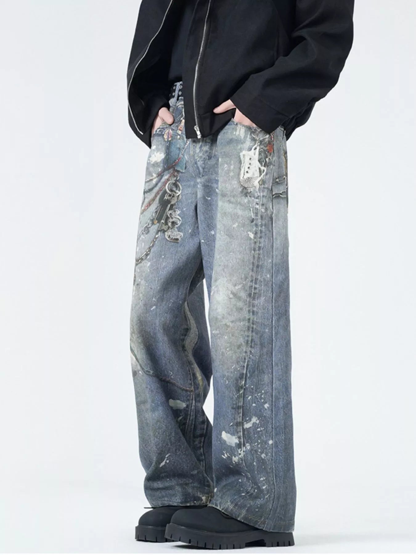 Men's wide-leg jeans in dusty blue denim with paint splatters and chain detail.