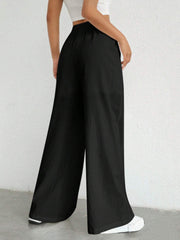Black linen wide-leg drawstring trousers with a relaxed fit.