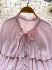 Pink chiffon blouse with ruffled neckline, bow tie, and button front.
