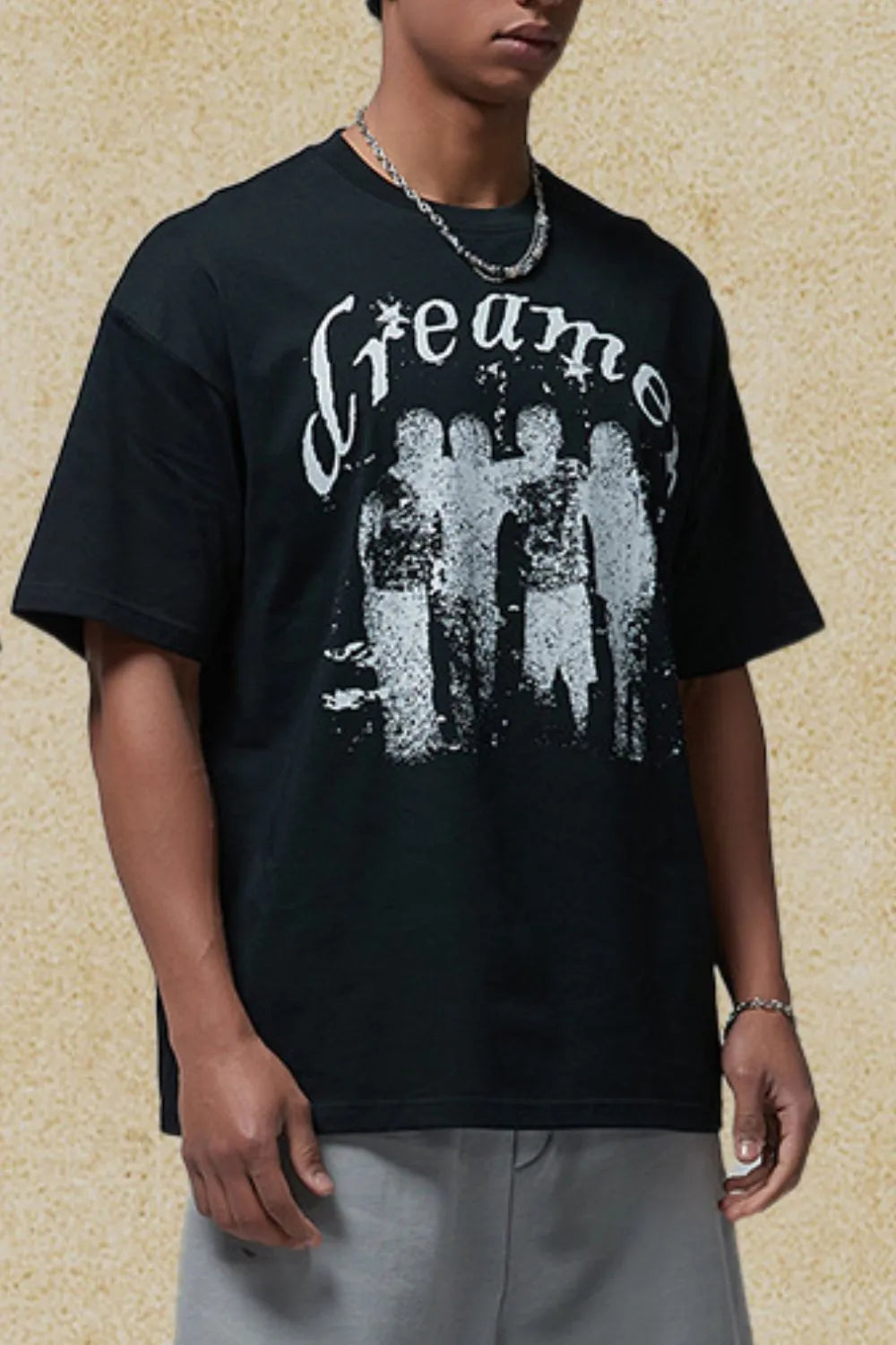 Black oversized graphic tee with white distressed "Dreamer" text and silhouette design.