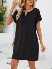 Black lace-trimmed V-neck pocket dress with short sleeves and a relaxed fit.