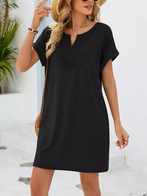 Black lace-trimmed V-neck pocket dress with short sleeves and a relaxed fit.