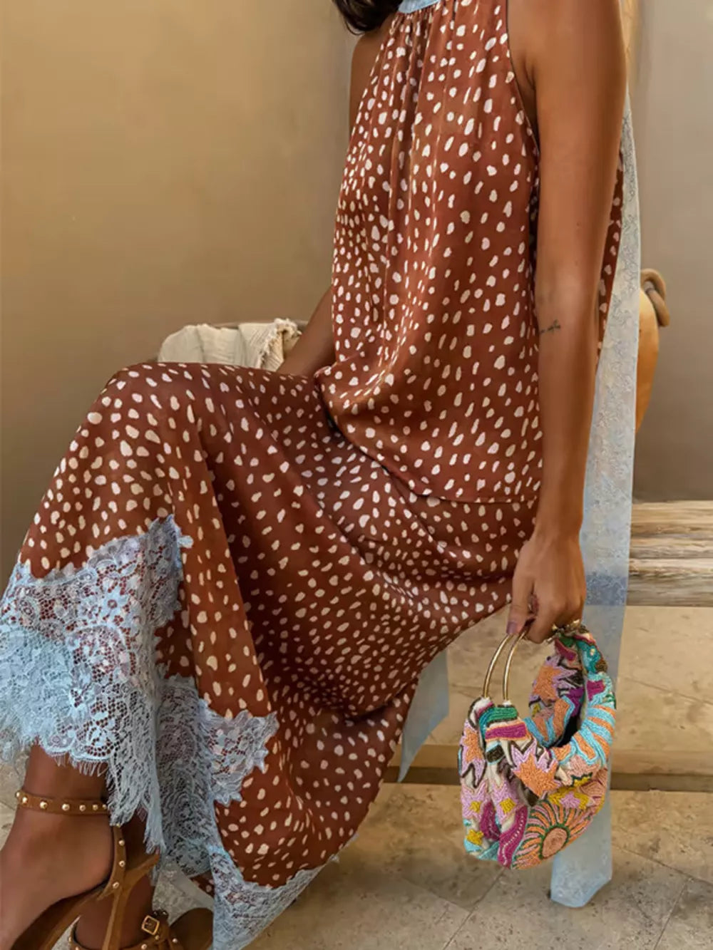 Brown polka dot maxi skirt with light blue lace trim and high neckline top.