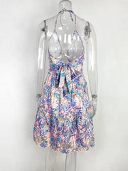 Abstract print halter mini dress with cutout back and tie detail in pink floral.