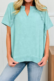 Distressed cotton tee with notched V-neck and lace insets.