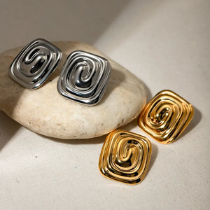 Sculpted swirl square earrings in gold and silver with a contemporary, chic design.