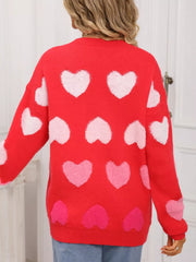 Red fuzzy knit sweater with allover pink and white heart pattern.