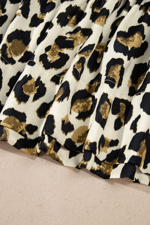 Leopard print tie-neck peplum blouse with ruffled hem detail.