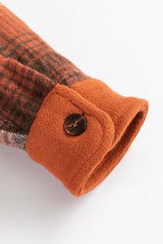 Colorblock plaid shacket cuff detail with button in terracotta and burnt orange plaid.