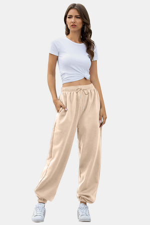 Relaxed-fit tan sweatpants with cuffed ankles and drawstring waist.