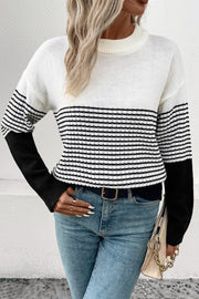 Colorblock stripe crewneck sweater in white with black sleeves and horizontal stripes.