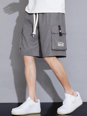 Grey cargo shorts with drawstring waist and utility pocket detail.
