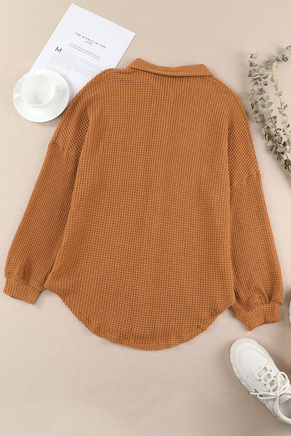 Caramel waffle knit button-down shirt jacket with collared neckline and long sleeves.