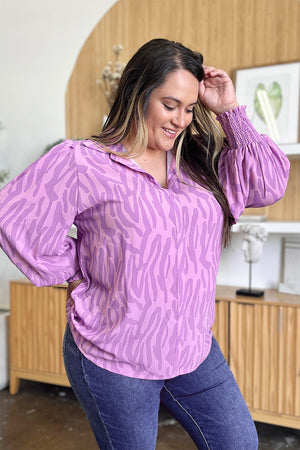 Lavender zebra print blouse with shirred cuffs and collared neckline.