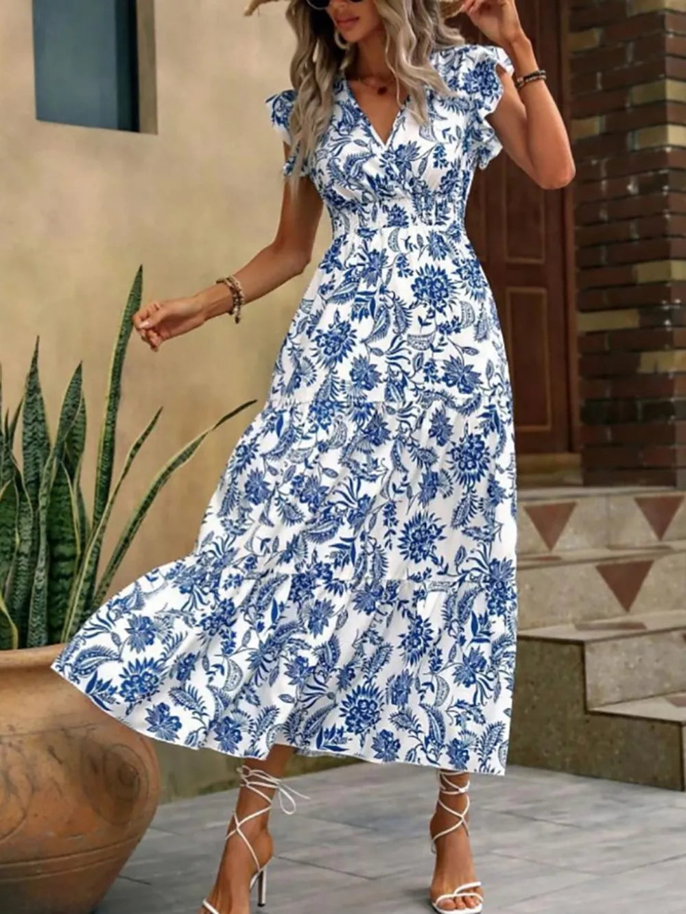 Botanical ruffle sleeve midi dress in white with blue floral print, V-neck, smocked waist, tiered skirt.