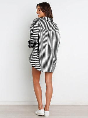 Oversized black and white striped shirtdress with a button-down collar and long sleeves.