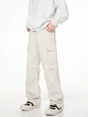 Men's loose fit cargo pants in creamy-white with multiple pockets.