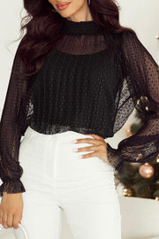 Black sheer mock neck blouse with textured dot pattern and ruffled cuffs.