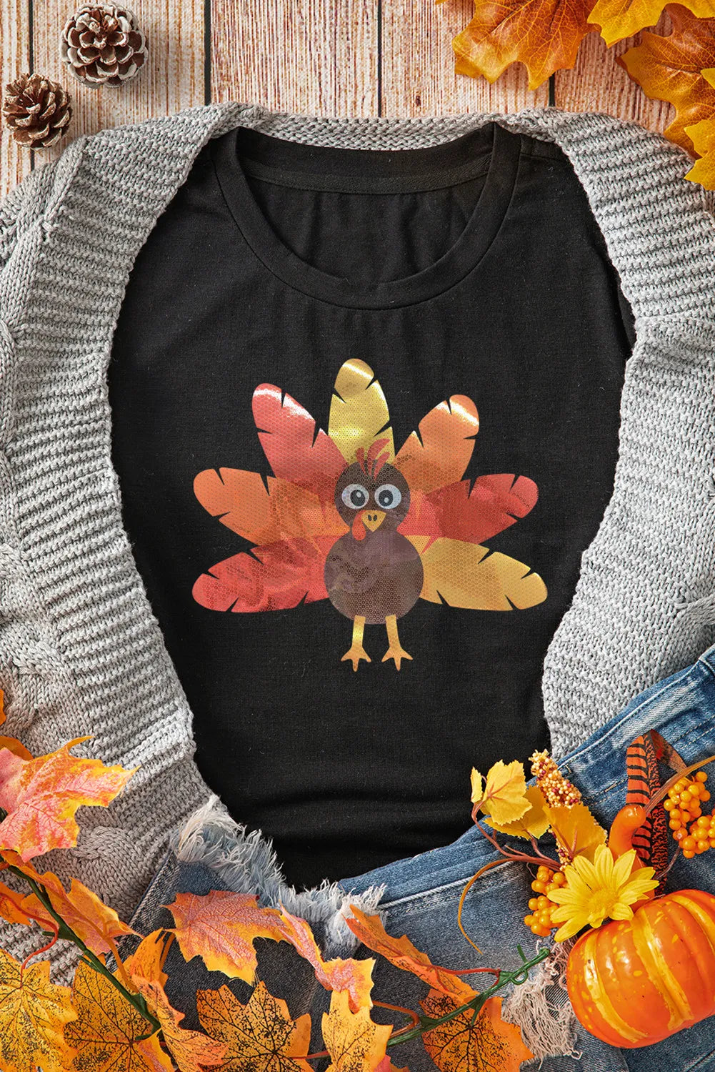 Black t-shirt with a feathered turkey graphic, round neck, short sleeves.