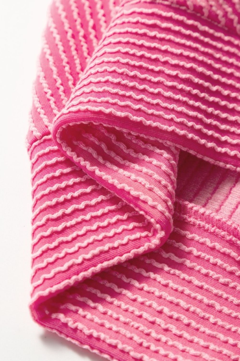 Fuchsia pink ribbed knit co-ord set with textured horizontal stripes and drawstring detail.