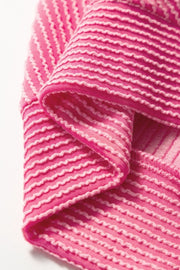 Fuchsia pink ribbed knit co-ord set with textured horizontal stripes and drawstring detail.